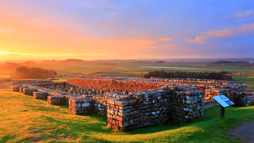 Roman Fort during sunrise with trees and landscape in the distance